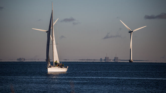 Сopenhagen, Denmark - December 26, 2014: Øresund is the sound separating the danish island of Zealand from Sweden. A substantial number of windmills are erected in the sound.