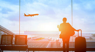 Business-traveller-looking-at-plane