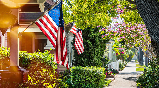 USA flag infront of california housing