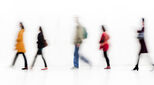 People walking in single file on white background