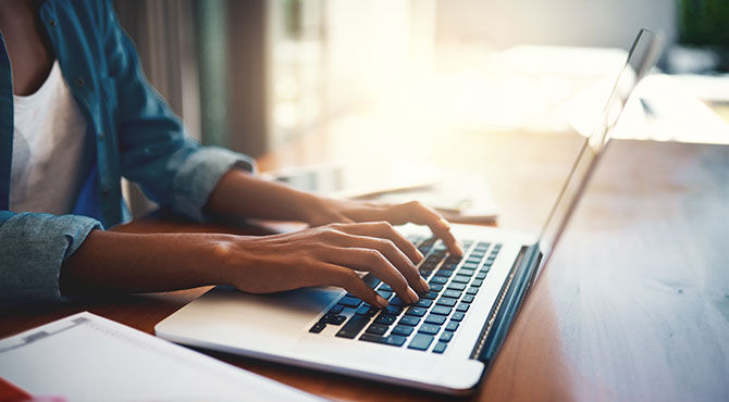 Hands typing on a keyboard