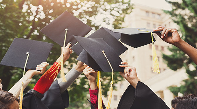 Graduates holding hats