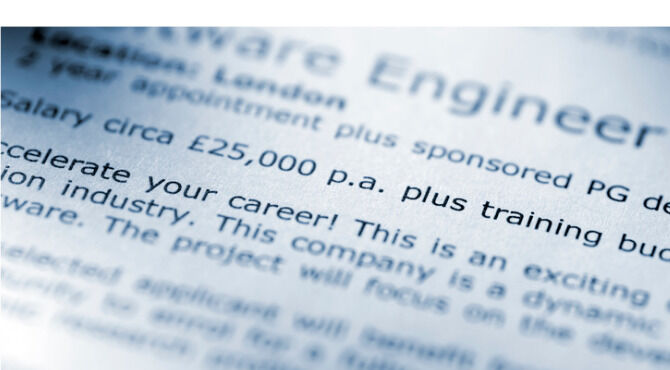 blue tinted selective focus shot of job advert