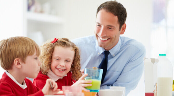 Father and two children eating breakfast