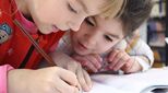 Two girls helping each other study