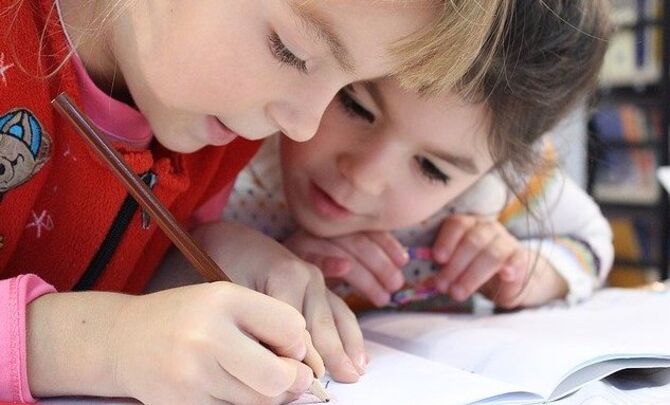 Two girls helping each other study