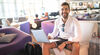 Man using laptop in hotel lobby