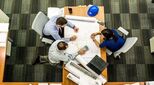 Architects meeting around blueprint