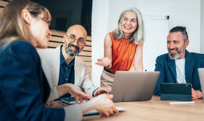 Image of men and women in office meeting