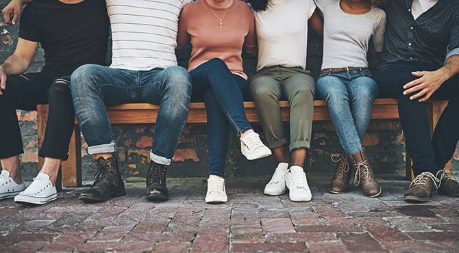 Millennials sitting together on a bench