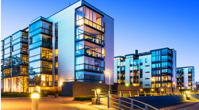 House building and city construction concept: evening outdoor urban view of modern real estate homes.