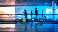 Motion blurred abstract people walking to the airport terminal