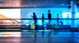 Motion blurred abstract people walking to the airport terminal