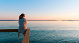 A woman relaxes by the sea