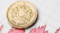 One pound coin on fluctuating graph. Rate of the pound sterling