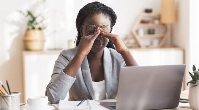 Business person on laptop looking stressed