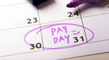 Image of calendar with pay day and a smiley face marked on