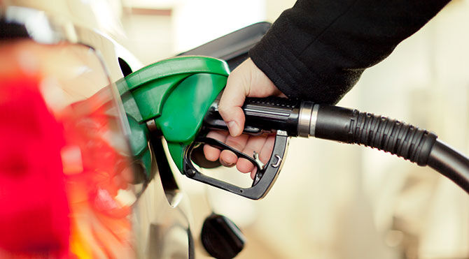Person filling car with petrol