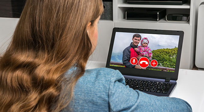 Photo of a woman calling her family while on international assignment