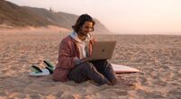 KIH-student-on-beach-surfboard