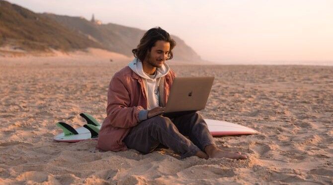 KIH-student-on-beach-surfboard