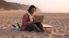 KIH-student-on-beach-surfboard