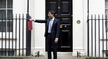 Chancellor of the Exchequer Rishi Sunak holds his red budget dispatch box aloft