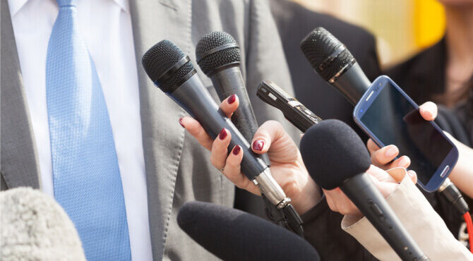 Broadcast media with female hand and male spokesperson