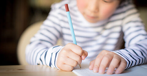 Toddler writing with pencil