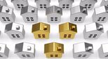 Row of model houses with three in gold