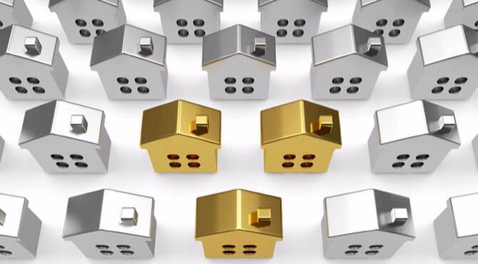 Row of model houses with three in gold