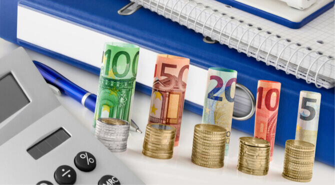 Image of calculator and stacks of Euro currency