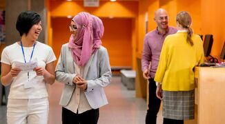 Image of happy university students talking in hallway