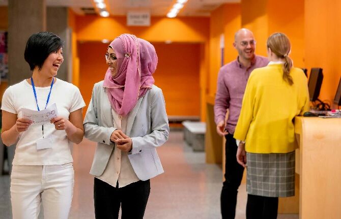 Image of happy university students talking in hallway