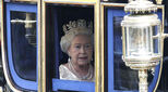 The Queen of England driving to Parliament in a carriage