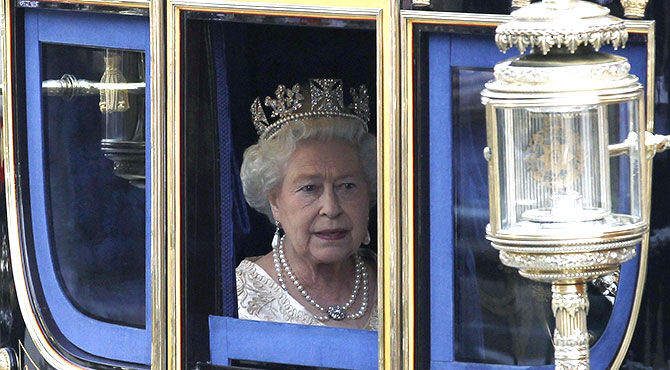 The Queen of England driving to Parliament in a carriage