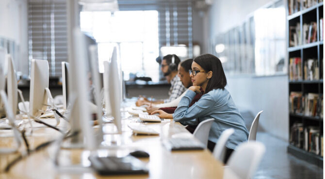 Image of female student studying in library