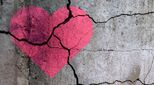Image of broken heart painted on concrete