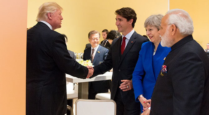 Photograph of Justin Trudeau and Theresa May meeting with Donald Trump