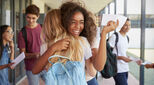 Image of young people celebrating in corridor