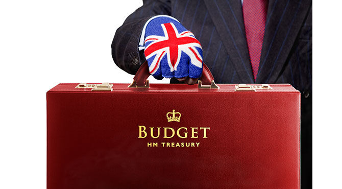 Red dispatch case with hand in union jack glove illustrates an article about the latest UK budget