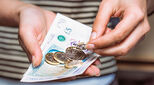 Shopper holding UK currency