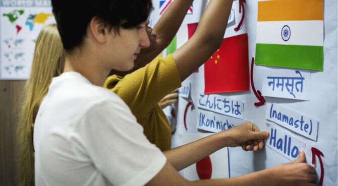 Young person putting India's flag up on wall