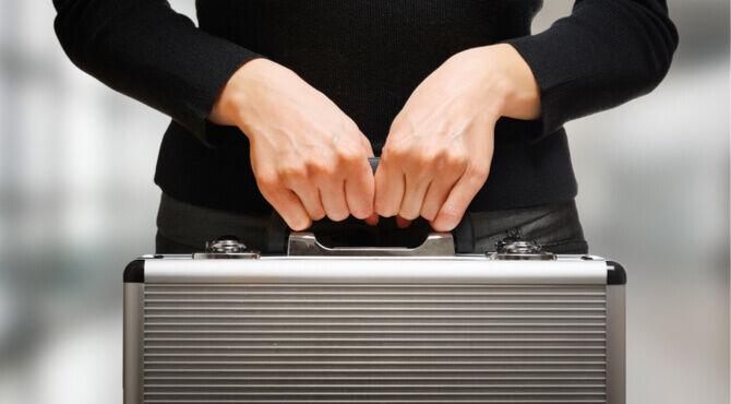 Women holding briefcase close to her