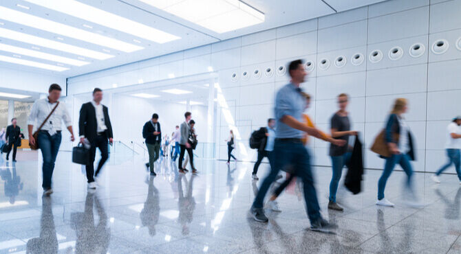 Image of people walking separately down a corridor