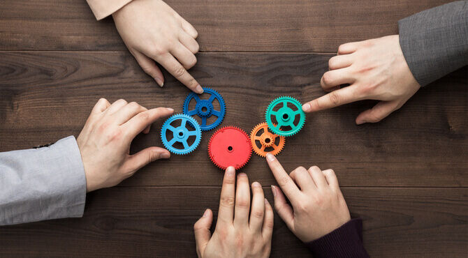 Productivity puzzle image of hands and cogs