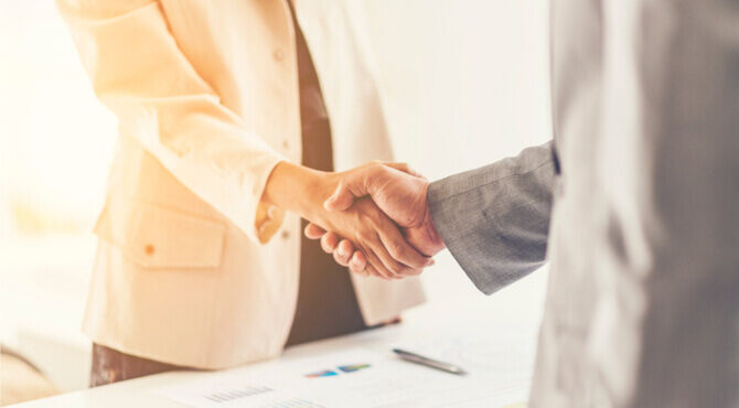 Two people shaking hands to seal the deal