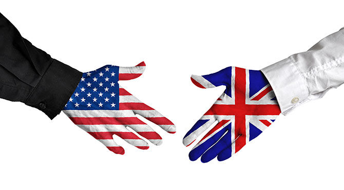 Two hands, with US and UK flag superimposed, shake hands