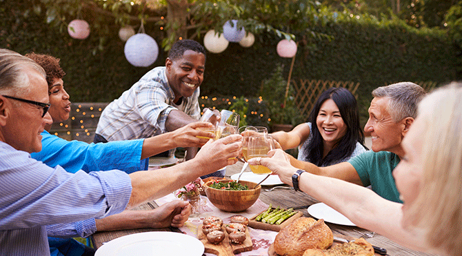 Mature friends toast at a barbecue