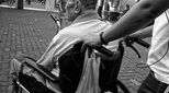 Image of man pushing wheelchair